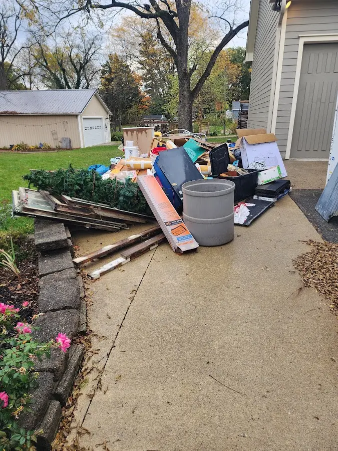 Dumpster being loaded with debris for 12 Yard Dumpster Rental in Exeter